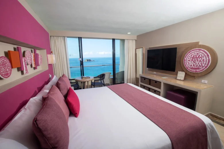 Sun Club Family Connecting king room with private balcony overlooking the Pacific Ocean at Sunscape Dorado Pacifico Ixtapa.