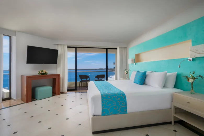 Sun Club Presidential Suite king bedroom with oceanfront balcony at Sunscape Dorado Pacifico Ixtapa.