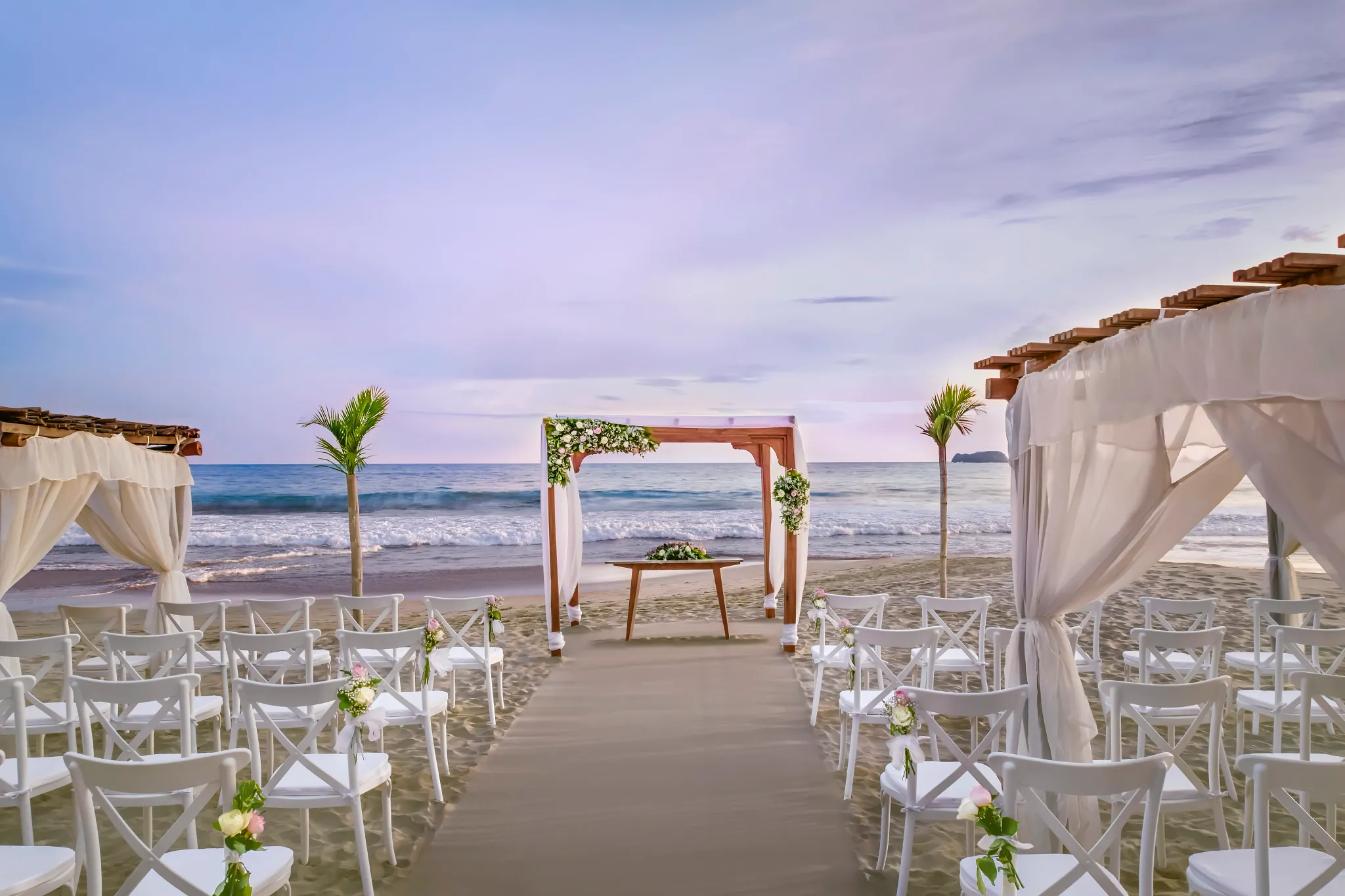 Beach wedding ceremony setup with wooden arch at Sunscape Dorado Pacifico Ixtapa