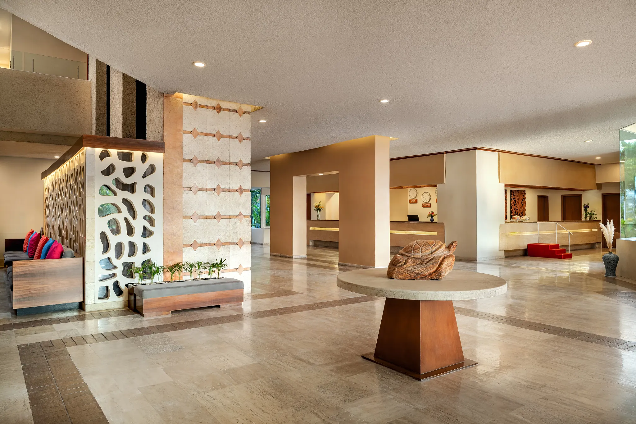 Spacious and modern resort lobby at Sunscape Dorado Pacifico Ixtapa with reception desk and seating area.
