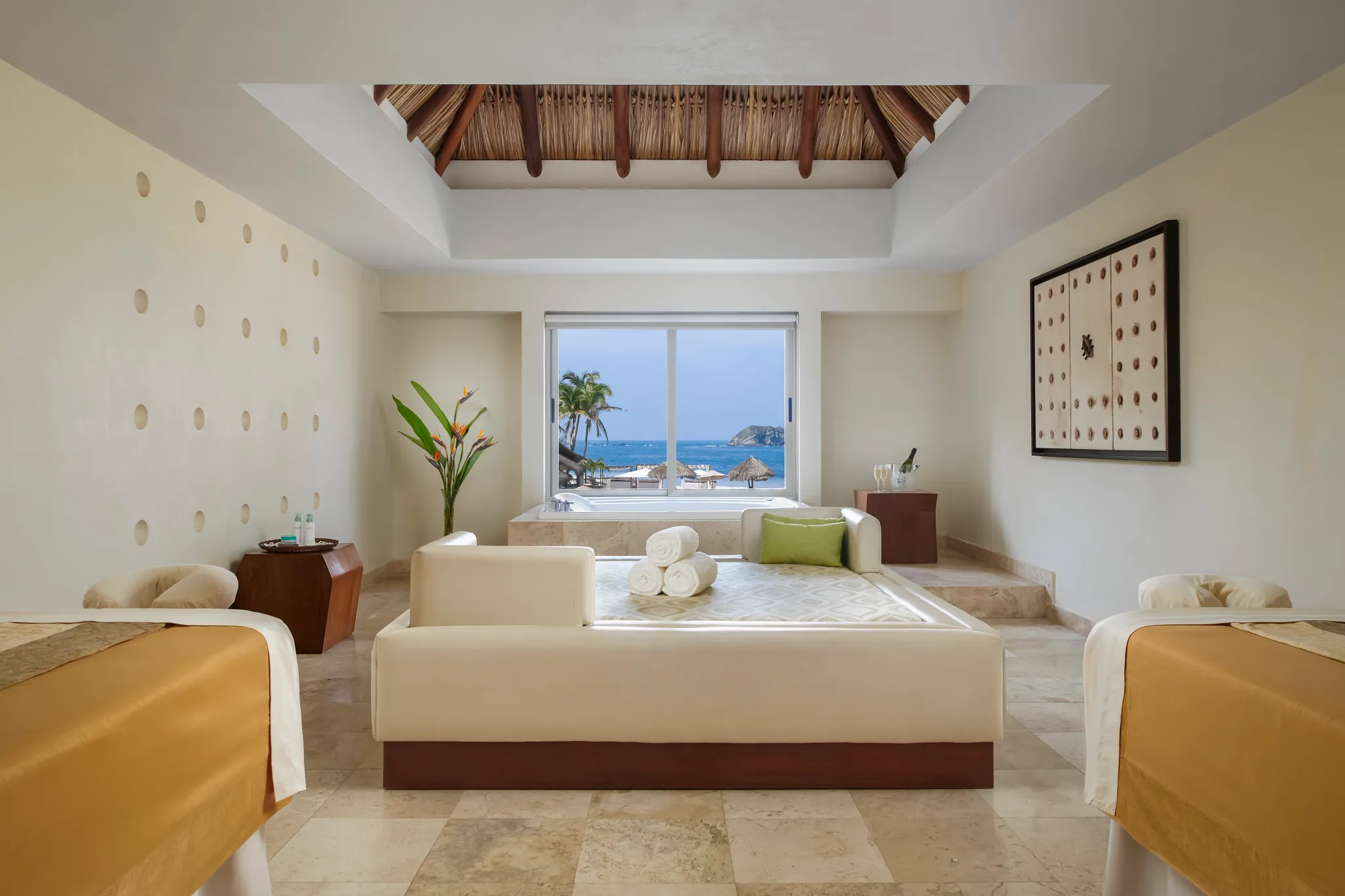 Elegant spa treatment room with massage tables and ocean view at Sunscape Dorado Pacifico Ixtapa.