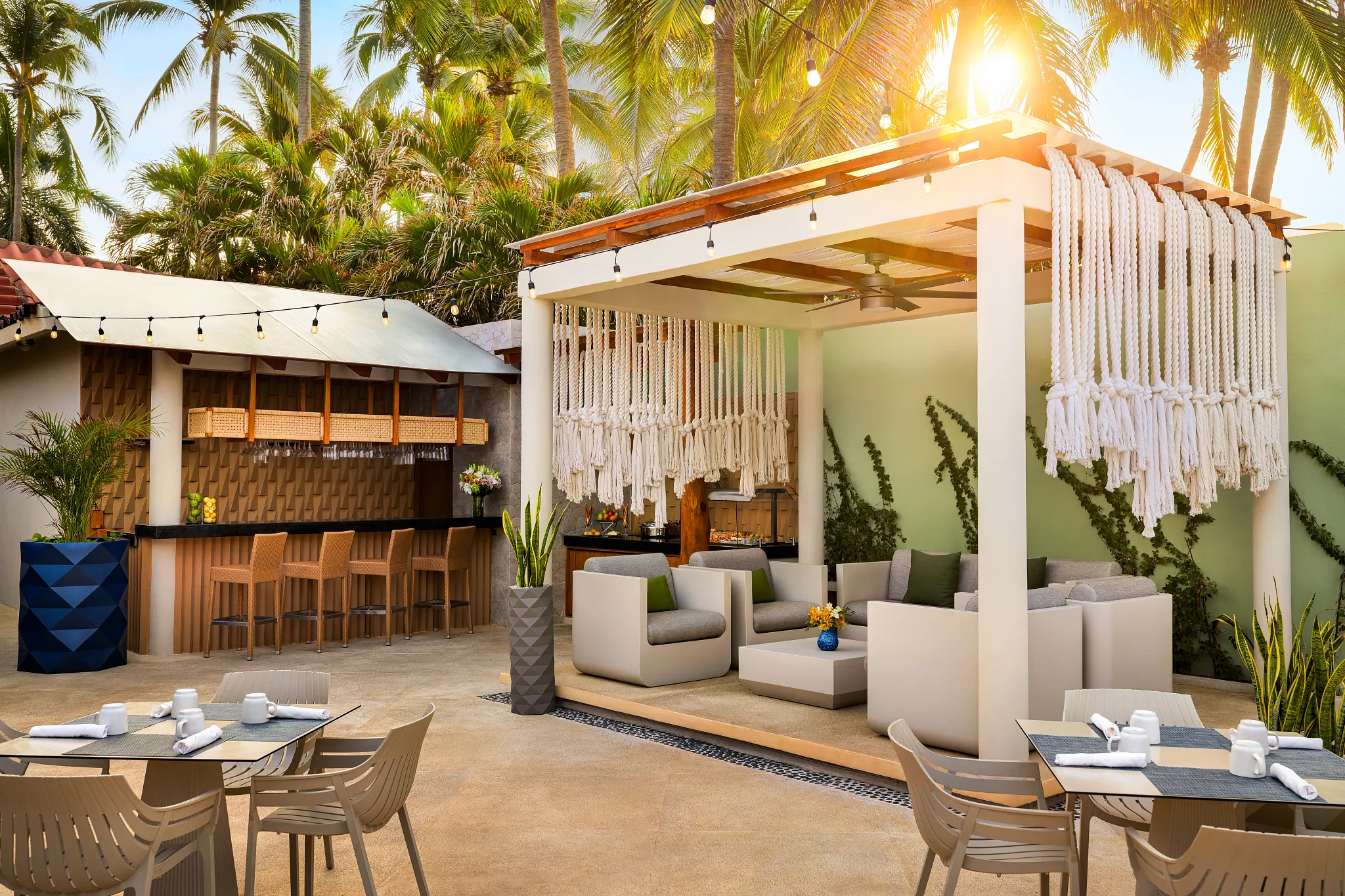 Outdoor Sun Club lounge area with modern seating and bar at Sunscape Dorado Pacifico Ixtapa.