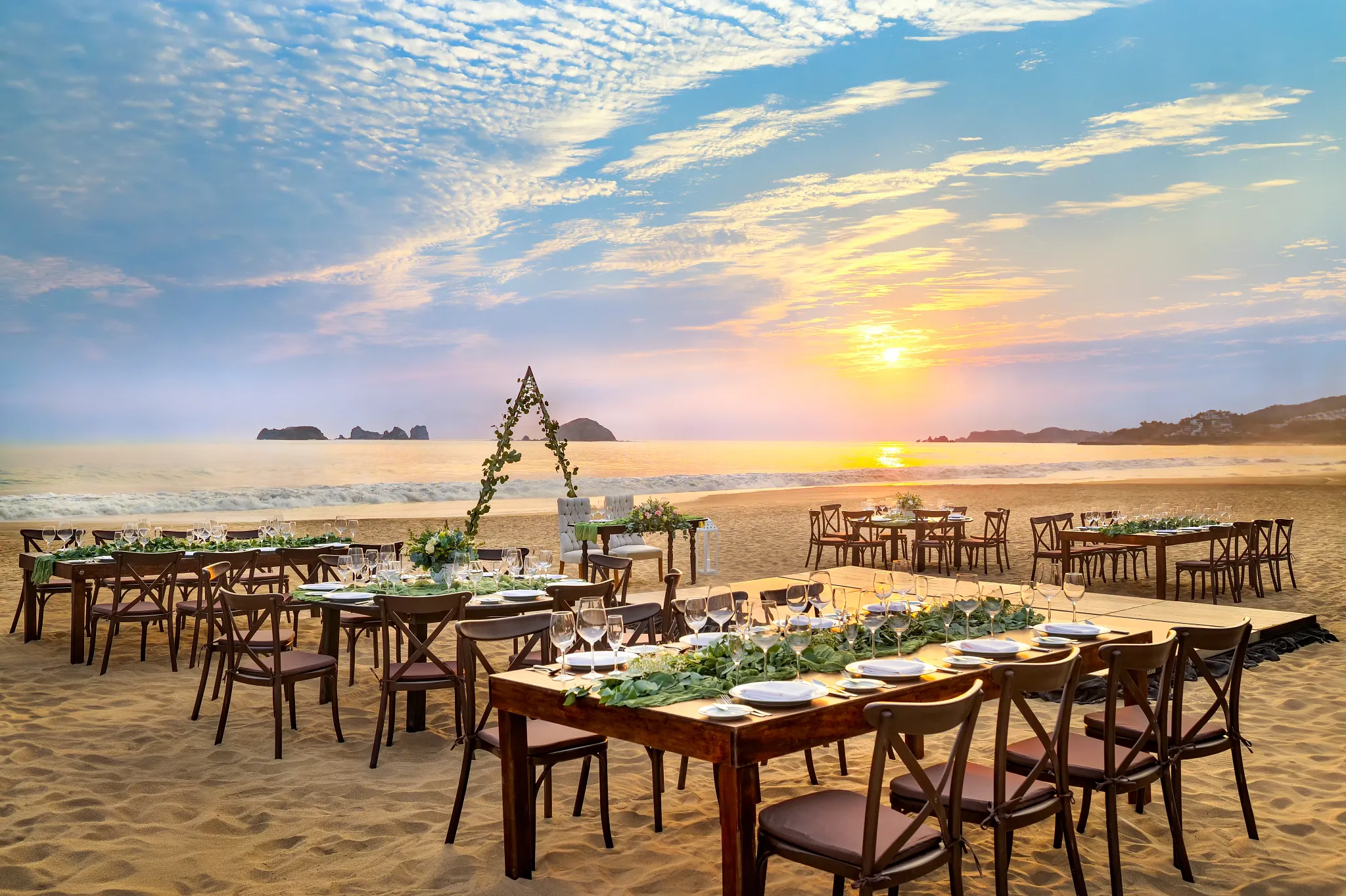 Sunset beach wedding reception with banquet tables at Sunscape Dorado Pacifico Ixtapa